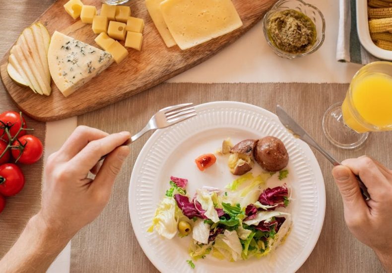 A vibrant lunch setting with salad, cheese, and orange juice, perfect for a healthy meal.