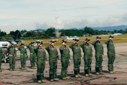 Group of uniformed military cadets saluting at an outdoor ceremony in Rionegro, Antioquia, Colombia.