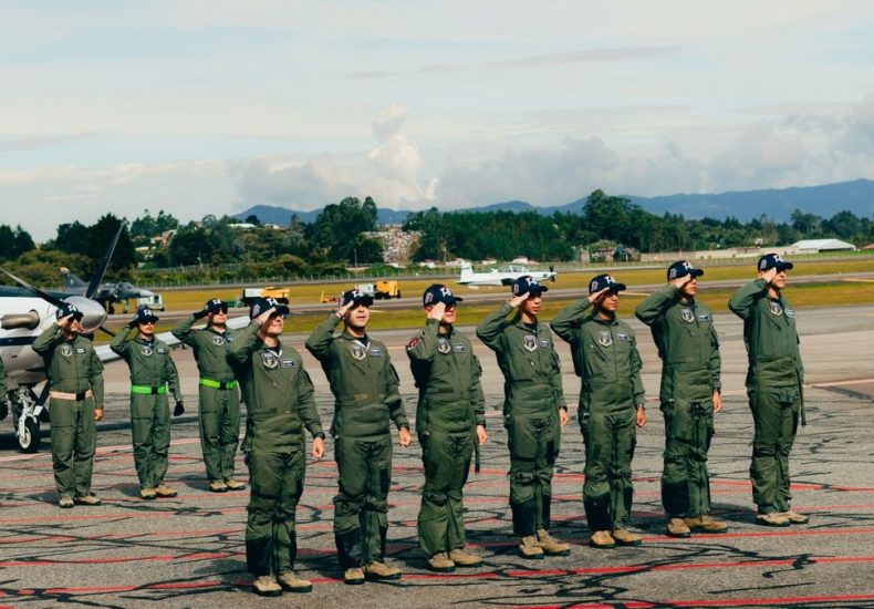 Group of uniformed military cadets saluting at an outdoor ceremony in Rionegro, Antioquia, Colombia.